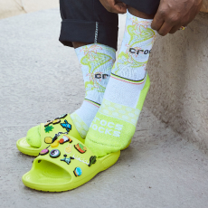 Bright neon Crocs with two feet that have socks 