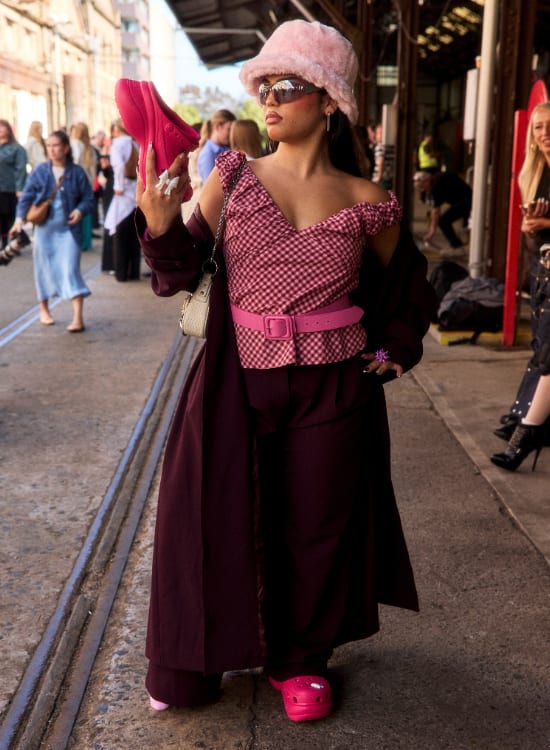 a woman walking down the street talking on a cell phone