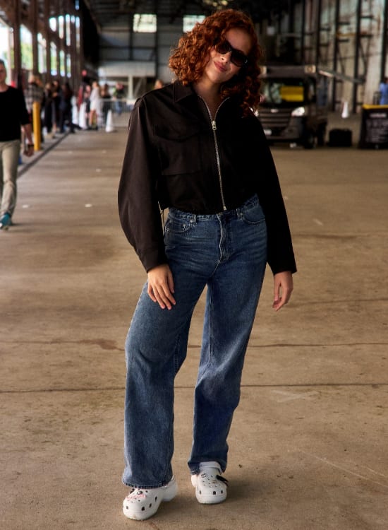 woman standing on a sidewalk
