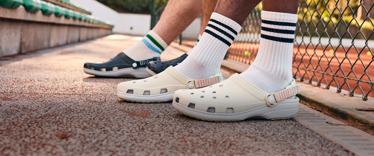 Person wearing white Crocs with socks