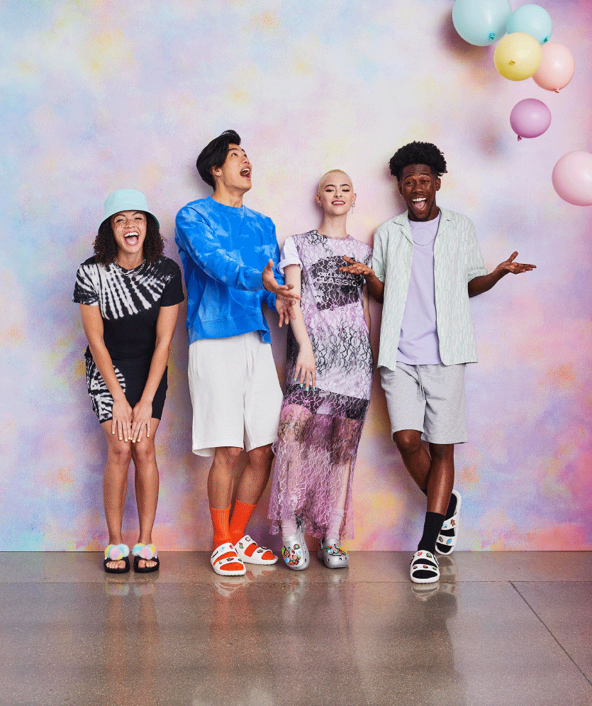 Animation of partygoers wearing Crocs while tossing festive balloons in the air.