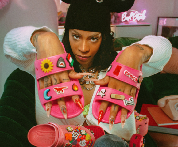 Rico Nasty with Crocs two strap slide.