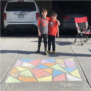 Kid in Crocs with Calk Art.