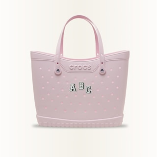 Varsity or collegiate style jibbitz charms, Letters A, B and C displayed on a large tote bag.